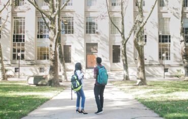 a couple of people that are standing in front of a building