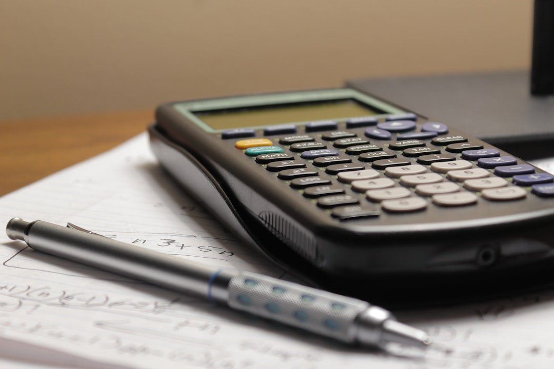 Class 12 Accountancy practice with calculator and notes
