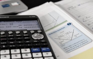 Class 10 Maths student studying mathematics with calculator and textbook