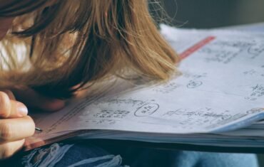 Student working through Class 11 Mathematics equations