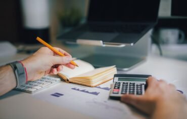 CBSE Class 12 Accountancy student studying accounting with calculator