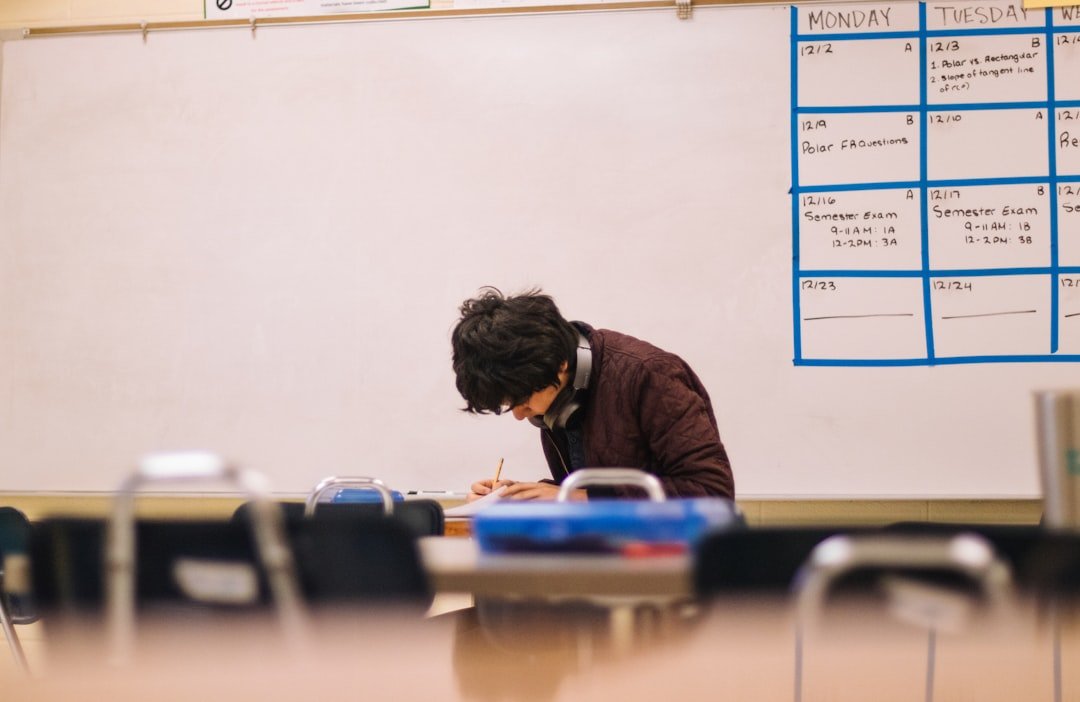 Class 12 student studying at a desk with books