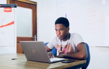 Student studying independently with a laptop at home