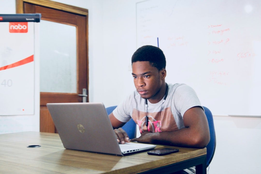 Student studying independently with a laptop at home
