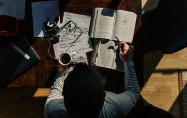 Student following a focused study routine with books and notes