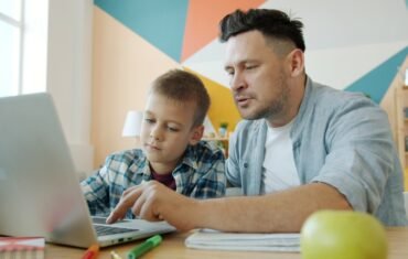 Parent and student using a laptop for homework and learning support