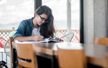 Class 10 English student studying with a book and notes
