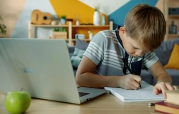 Student studying at home with laptop