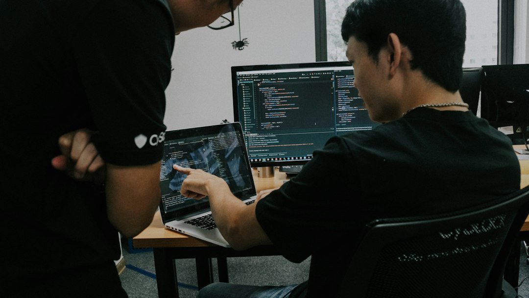 Developers working with computers for online Computer Science tuition