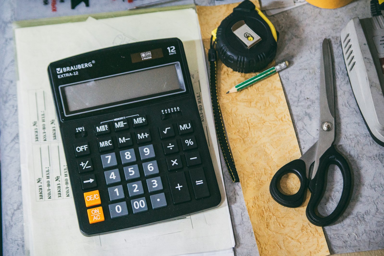 Calculator and financial paperwork representing cost accounting study