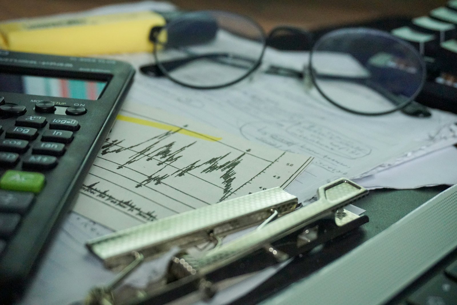 Calculator and financial reports on a desk for financial management study