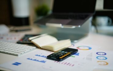 Financial charts and calculator on a desk for management accounting learning